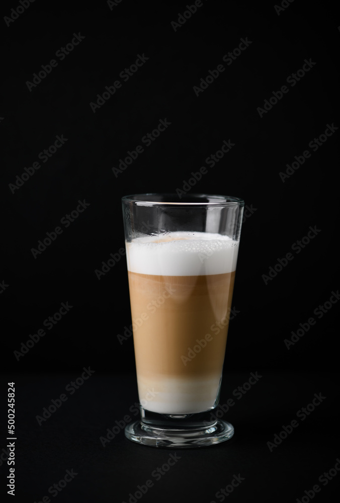 Coffee with milk on dark background. Close up. Copy space. Coffee with milk on dark background. Close up. Copy space.
