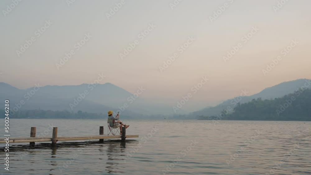 Asia serene people blogger vlogger look at rural water river share content creator get away staycation vlog on IG reel tiktok app post photo by 5G wifi and relax enjoy tour with sunlight fog mist sky. Asia serene people blogger vlogger look at rural water river share content creator get away staycation vlog on IG reel tiktok app post photo by 5G wifi and relax enjoy tour with sunlight fog mist sky.