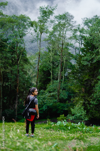 young latin woman in the jungle hiking, appreciating nature and natural conservation, colombia quindio