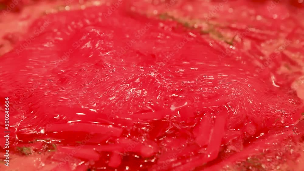 Cooking at home. Macro shot of the surface of boiling red beetroot soup in the pot. Cooking at home. Macro shot of the surface of boiling red beetroot soup in the pot.