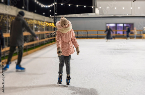 the child was skating on the ice rink
