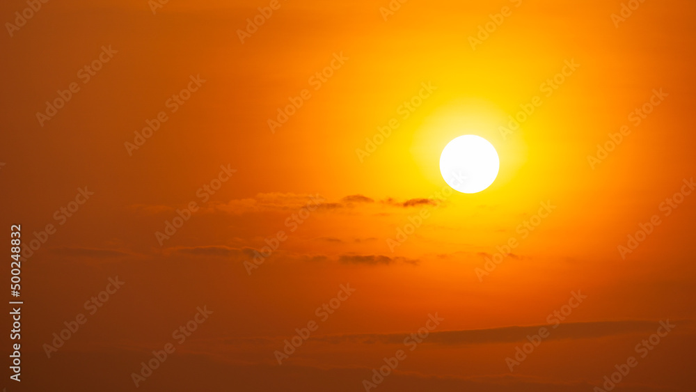 The bright sun is shine on the on the morning orange sky and small clouds The bright sun is shine on the on the morning orange sky and small clouds