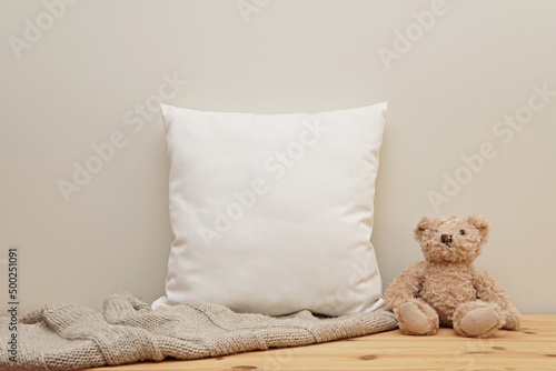 White square cotton pillow case mockup, neutral baby or kids canvas cushion mock up in nursery interior. photo