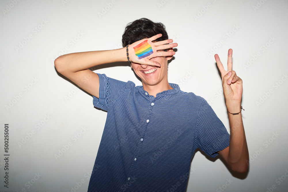 Naklejka premium Cheerful gay man with rainbow pride flag painted. Retro Style.