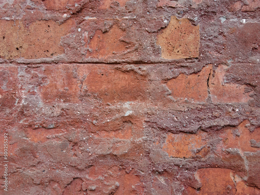 Rough brick wall with pieces of cement Rough brick wall with pieces of cement