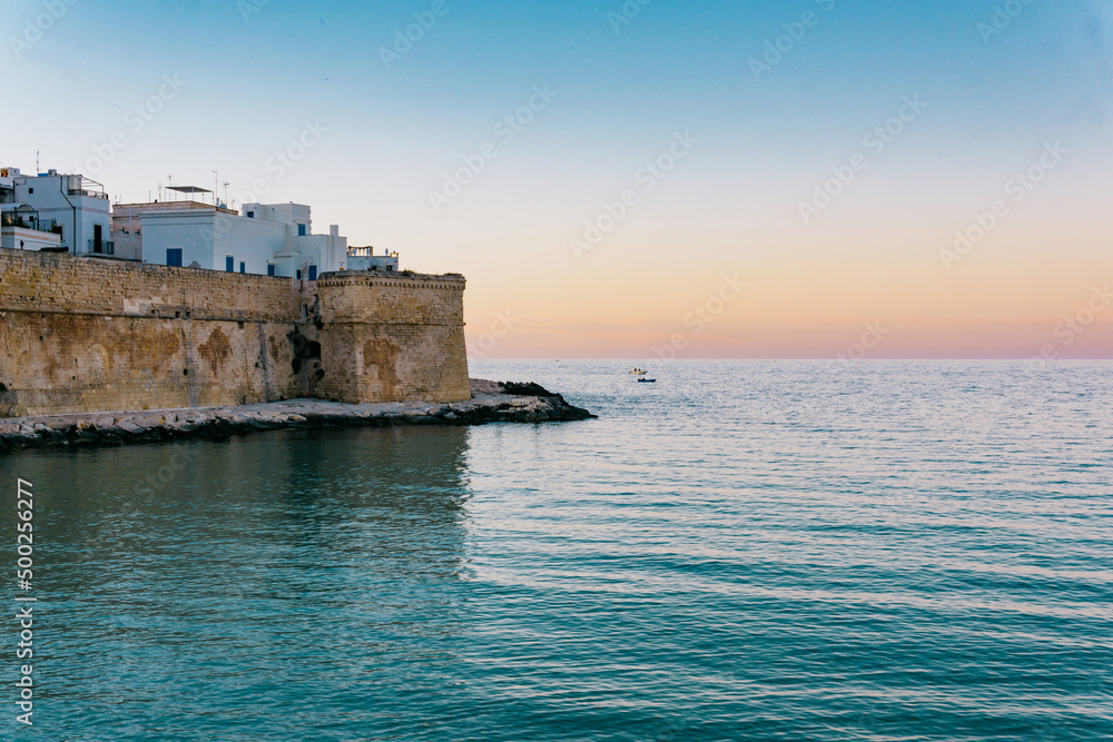 Overview of the old city walls in the historic center of Monopoli in Puglia (Apulia - southern Italy) - View of the ancient beach called 