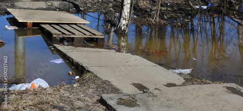 Improvised makeshift bridge over a ditch with water