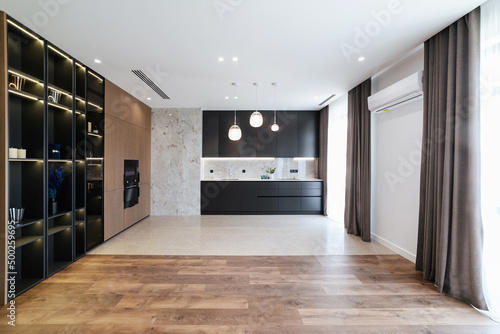 Modern design of the interior of a black kitchen in a loft style