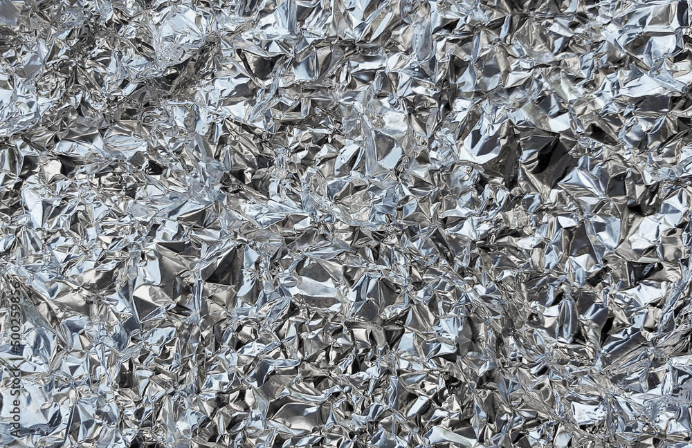 Silver foil with shiny crumpled surface texture background Silver foil with shiny crumpled surface texture background