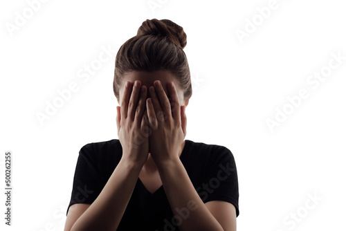 Silhouette of woman that closed her face by hands. Isolated portrait on white background