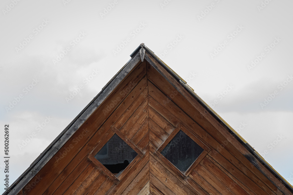 Wooden roof of an old house with windows. Wooden roof of an old house with windows.