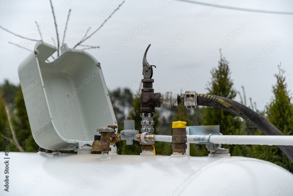 Refueling the propane gas tank for home heating. Purchase and price of LPG.  Tank for gas installation in a single-family house. Stock-Foto | Adobe Stock