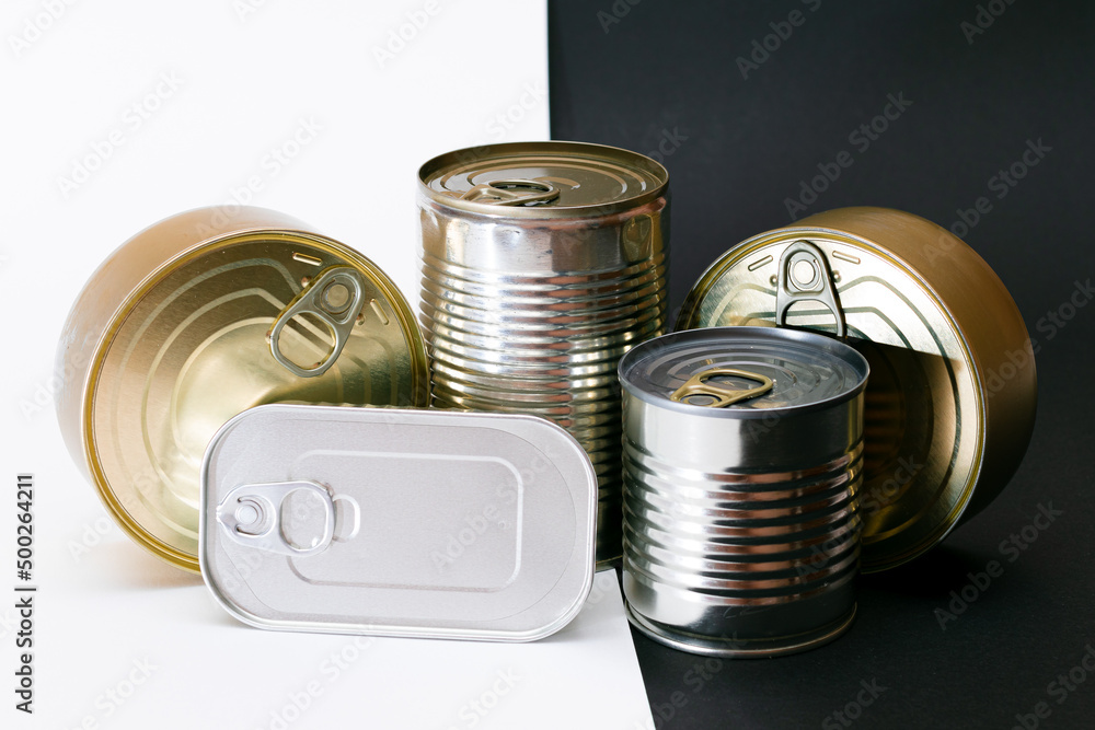 A Group of Stacked Tin Cans with Blank Edges on Split Black and White Background. Canned Food. Different Aluminum Cans for Safe and Long Term Storage of Food. Steel Sealed Food Storage Containers A Group of Stacked Tin Cans with Blank Edges on Split Black and White Background. Canned Food. Different Aluminum Cans for Safe and Long Term Storage of Food. Steel Sealed Food Storage Containers