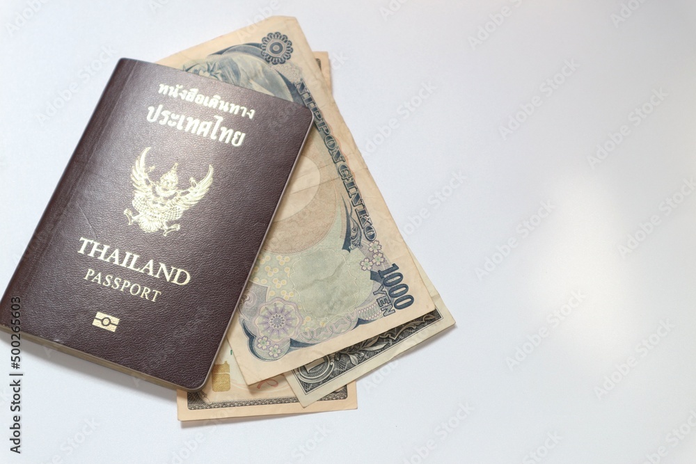 Yen, dollar, baht and passport on white background Yen, dollar, baht and passport on white background