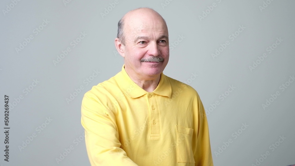 Senior hispanic man with mustache looking at camera without emotions. Senior hispanic man with mustache looking at camera without emotions.