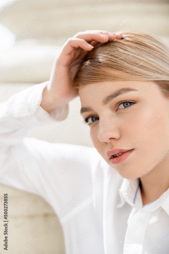 Fototapeta premium portrait of young blonde woman looking at camera outdoors.