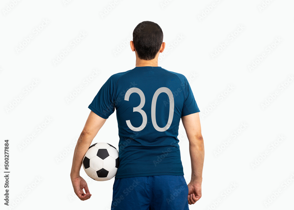 Cropped image and rear view of a young player with number thirty holding a soccer ball under his arms with white background Cropped image and rear view of a young player with number thirty holding a soccer ball under his arms with white background