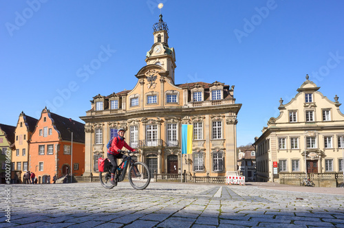woman on bicycle tour in downtown of Schwaebisch Hall, one of the most famous  medieval cities in Germany  #500278662
