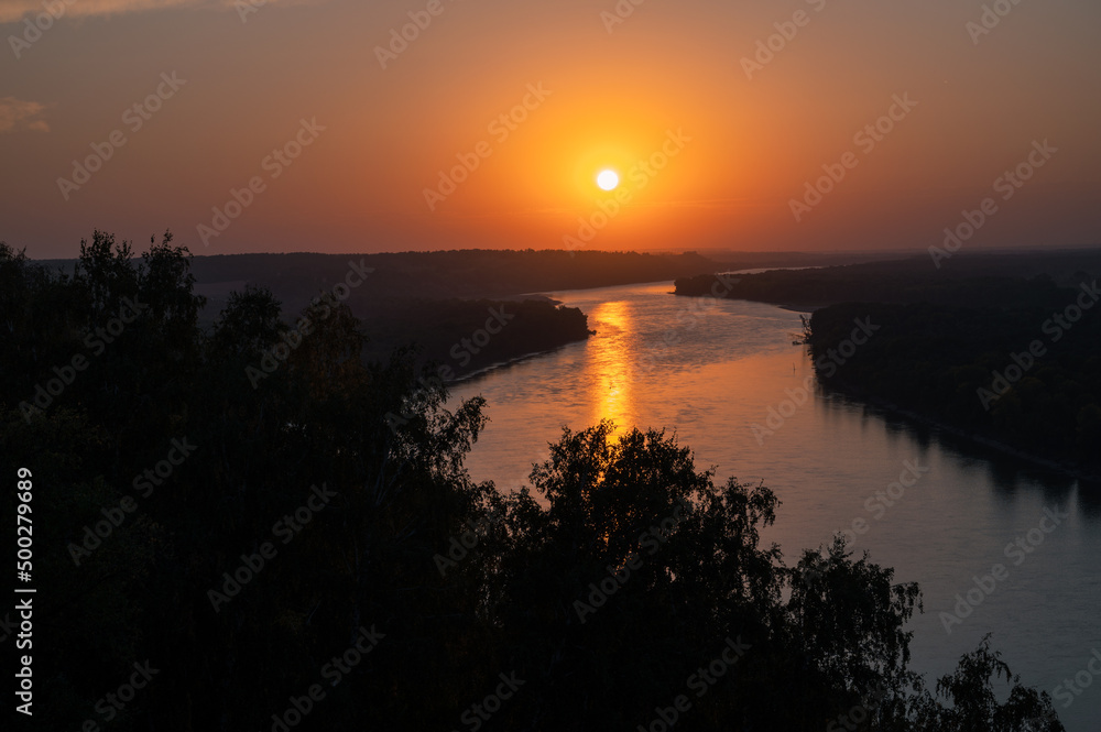 View of river landscape in sunny summer sunset. Top view of siberian Ob river from high attitude in summer sunset.