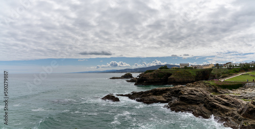 coastline in Galicia near Foz with green meadows and homes on the seashore