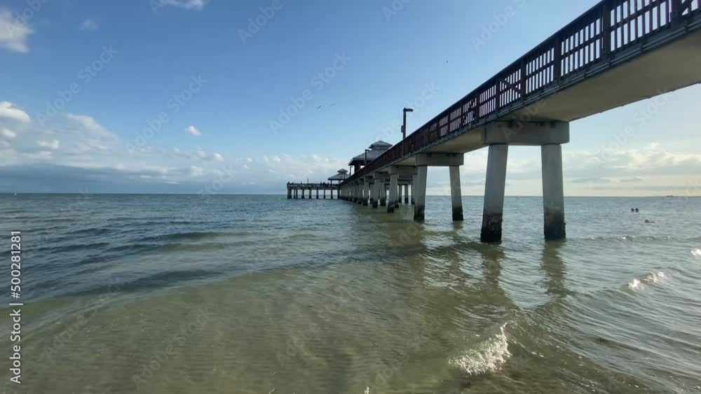 Waves rolling underneath Florida Fort Myers Pier, beach US Waves rolling underneath Florida Fort Myers Pier, beach US