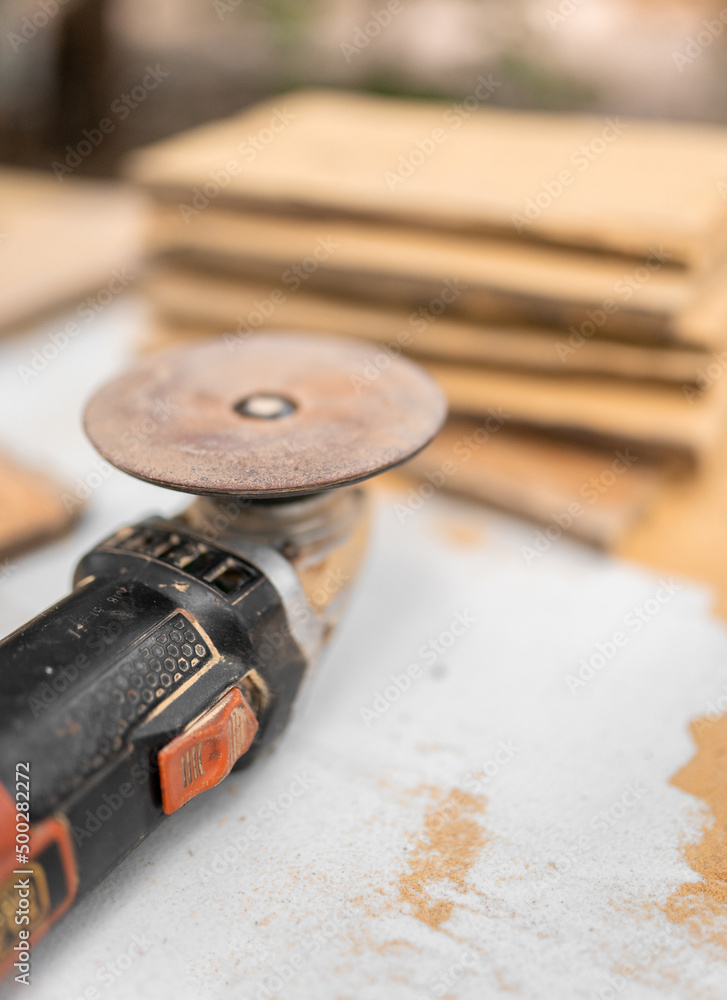 Grinder near stack of wooden boards Grinder near stack of wooden boards