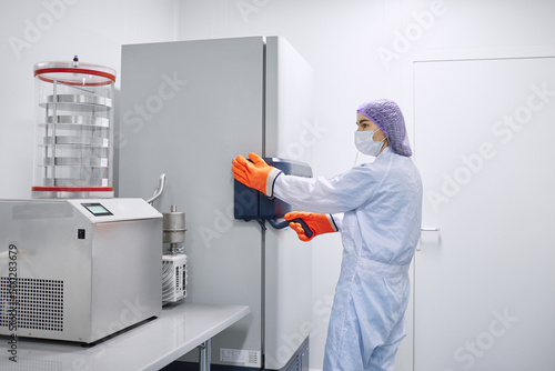 Scientists work in the laboratory. Remove the biomaterial from the freezer