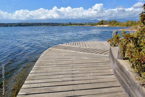 Tela wooden footbridge over water at the shore of a lake