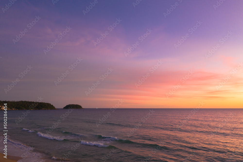 Obraz premium aerial view wave after wave swept towards the shore. .Landscapes view of beach sea sand and wave in sunset. .Beach sea space area. waves crashing at Karon Beach, Phuket Thailand.