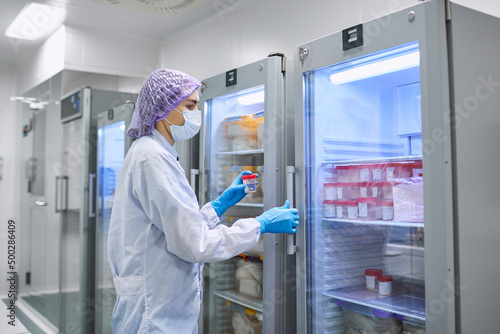 Wallpaper Mural A girl scientist checks a sample for research Torontodigital.ca