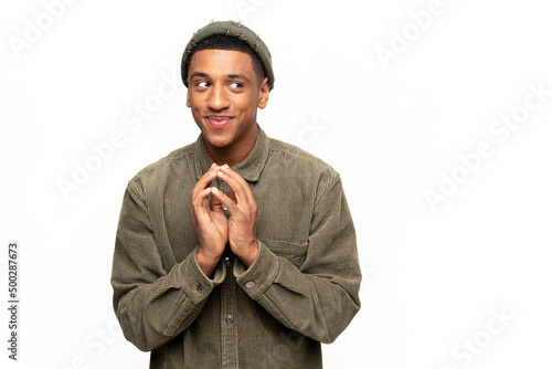 Sneaky man gesticulating with fingers planning devious tricks and cheats, scheming prank, having fun. Indoor studio shot isolated on white background photo
