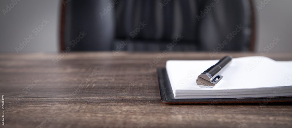 Notepad and pen on the business desk. Notepad and pen on the business desk.