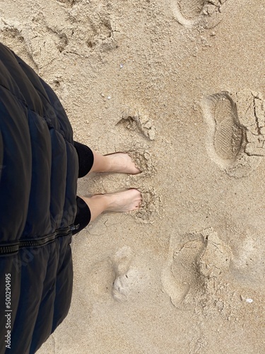 feet on the beach on the sand