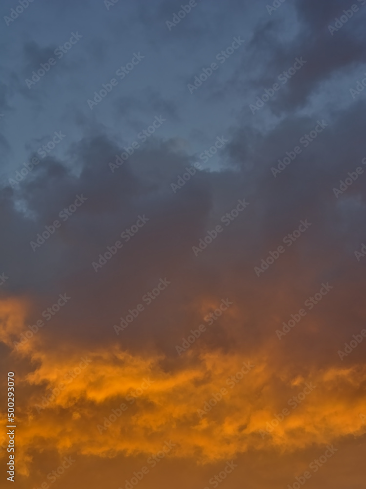 Colorful cloudy evenig sky in blue, orange and grey