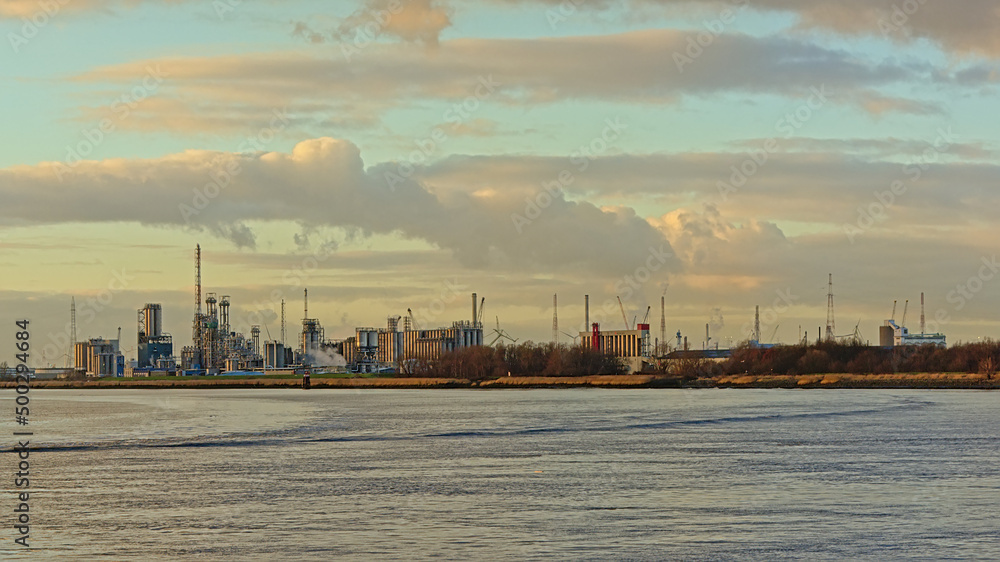 Industrial buildings along river Scheldt in the port of Antwerp, Flanders, Belgium