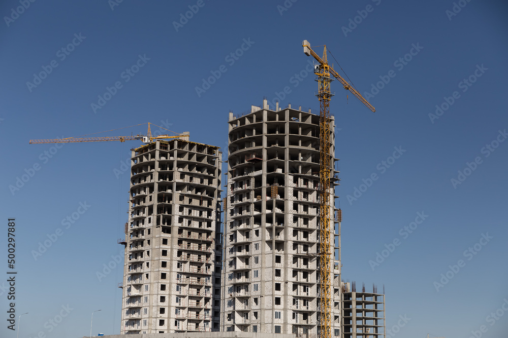 Construction of the city, new buildings with the use of construction equipment.