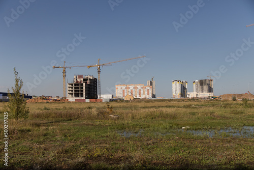 Construction of the city, new buildings with the use of construction equipment.