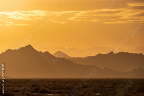 Rugged reliefs of the mountains in the Iranian desert at sunset