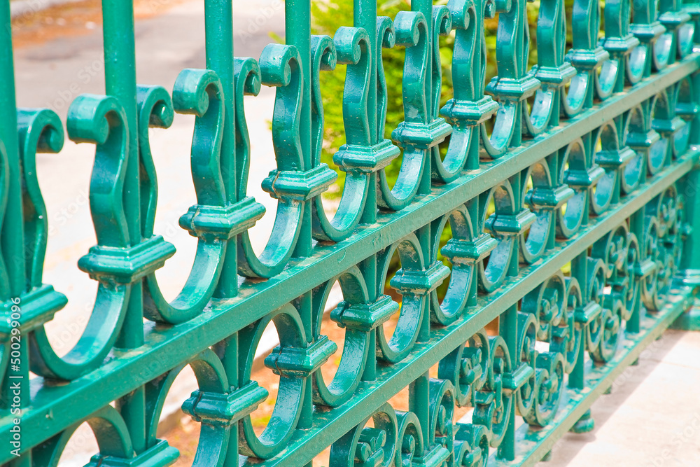 Old green wrought iron grating with floral decorations Old green wrought iron grating with floral decorations