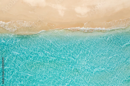 Beautiful aerial beach landscape, summer vacation holiday template banner. Waves surf with amazing blue ocean lagoon, sea shore, coastline. Amazing aerial drone top view. Relaxing bright beach seaside