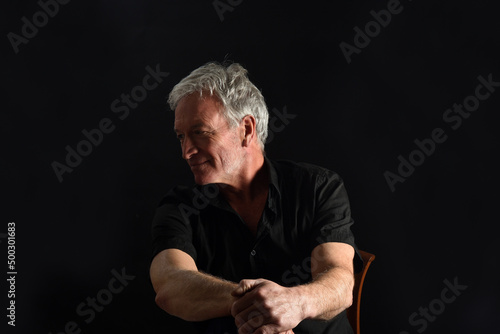 man looking away on black background