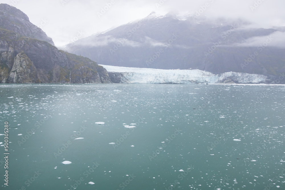 Ice chunks in the water and glacier in background at Glacier Bay, Alaska, USA Ice chunks in the water and glacier in background at Glacier Bay, Alaska, USA