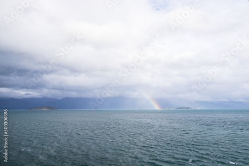 Storm clouds and rainbow over the ocean