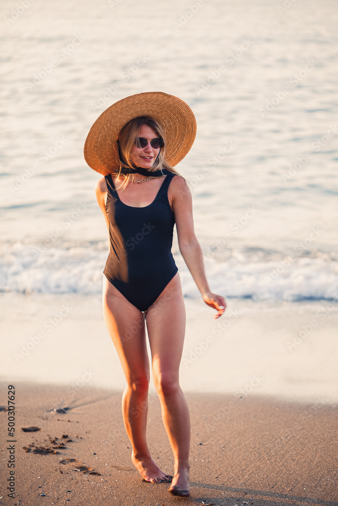 custom made wallpaper toronto digitalBeautiful girl in a black swimsuit and hat on a sandy beach at the sea in the sunset sunlight