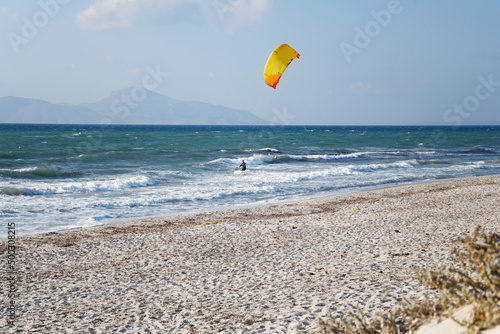 a kite-surfer on the waves; sandy beach in Mastichari on Kos island (Greece)