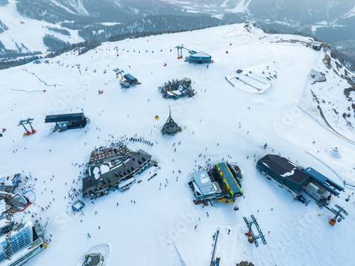 Aerial view of various ski stations on snow covered mountain. Beautiful white landscape at kronplatz in south tyrol. Alpine tourist attraction during winter. photo