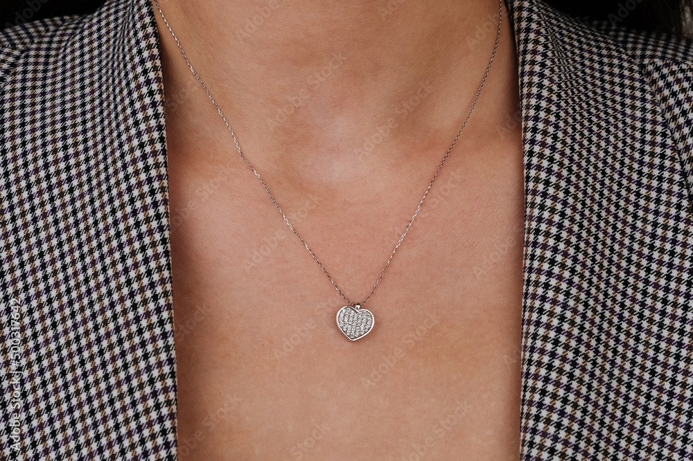 Close up necklace on necklace girl's neck. Beautiful woman wearing black jacket style with diamonds, six, diamond necklace, luxury fashion jewelry. Close up necklace on necklace girl's neck. Beautiful woman wearing black jacket style with diamonds, six, diamond necklace, luxury fashion jewelry.