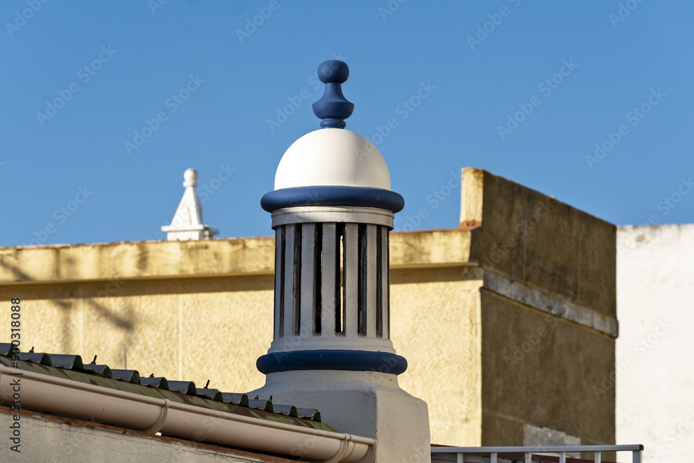 Fototapeta premium traditional openwork chimney on a roof in Fuseta, Algarve, Portugal..