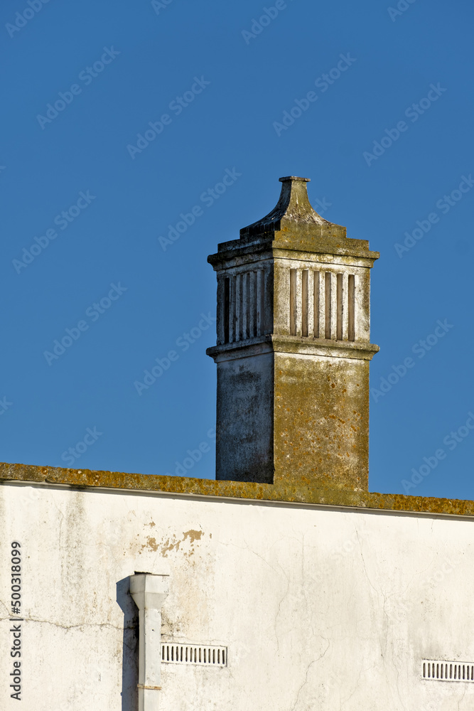 Obraz premium traditional openwork chimney on a roof in Fuseta, Algarve, Portugal..