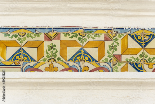 frieze of azulejos on a restored house in Fuseta, Algarve, Portugal